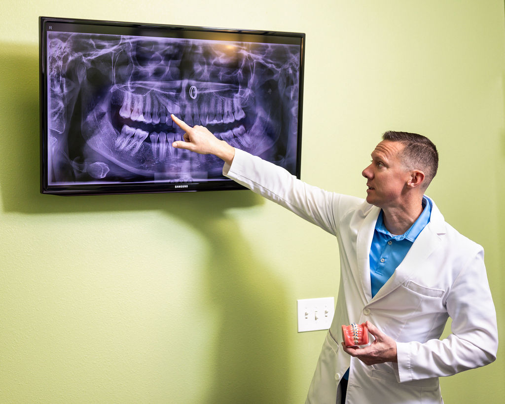 Orthodontist At Prosper Trail Orthodontics Explaining Teeth Alignment Treatment To A Patient