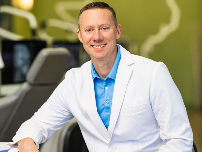 Doctor At Prosper Trail Orthodontics Smiling In A Professional Orthodontic Office